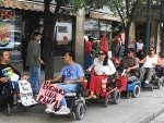 Jose Lara, Ruben Fernandez, Myra Murillo and other Desert ADAPTers in wheelchairs block the front of the inaccessible downtown burger king
