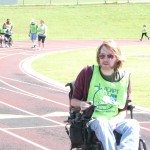 Eric Clow steers his motorized wheelchair around the Yellow Jacket Stadium track
