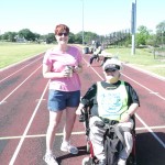 Nancy Crowther and another Fun Runner get ready to do their laps on the Yellow Jacket stadium tack