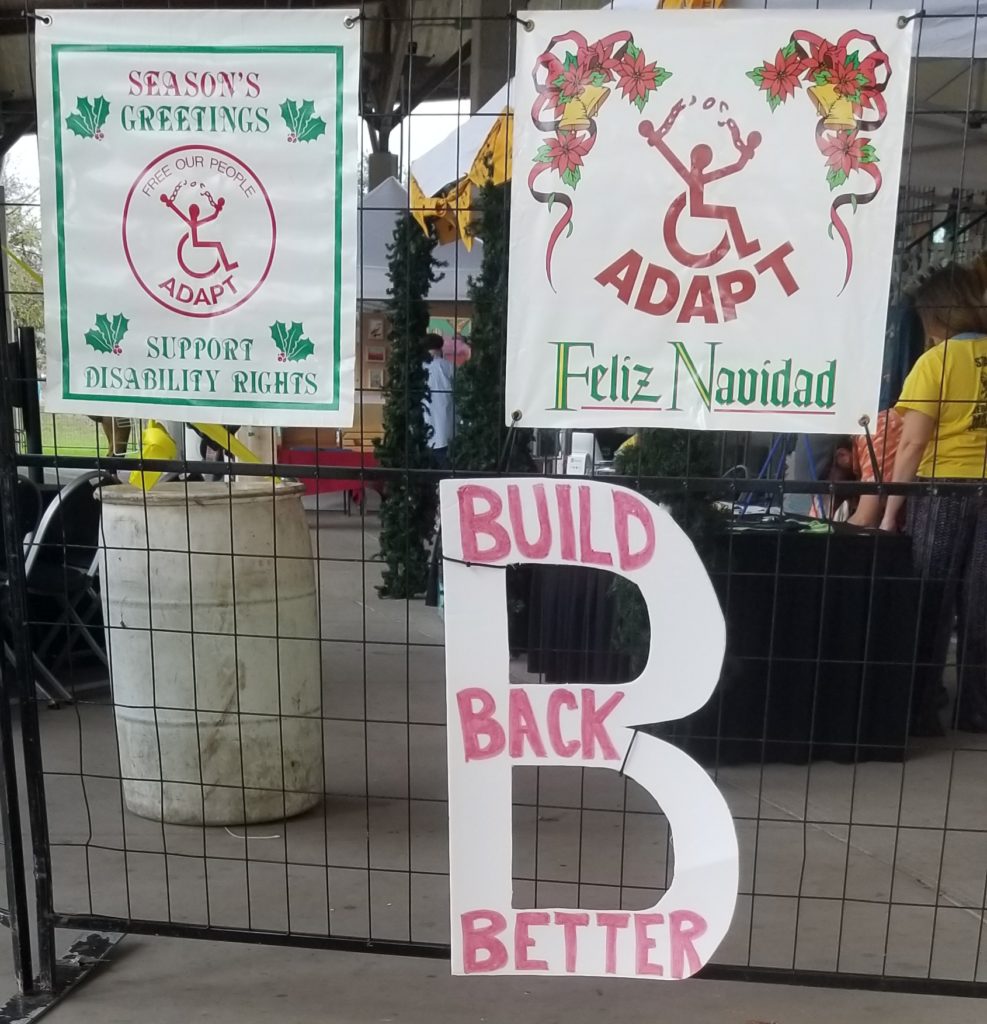 picture of two ADAPT holiday banners and our Build Back Better B sign.