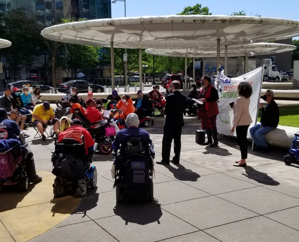 ADAPT activists led by Rhoda Gibson negotiate with HUD officials on the plaza in front of HUD HQ