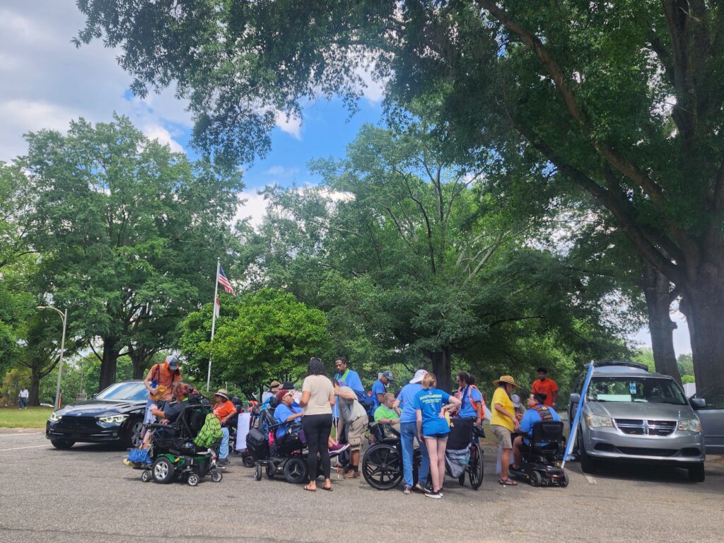 Group of people huddled in parking lot.