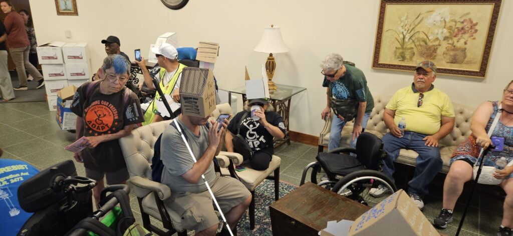 ADAPT folks wearing house box hats in lobby