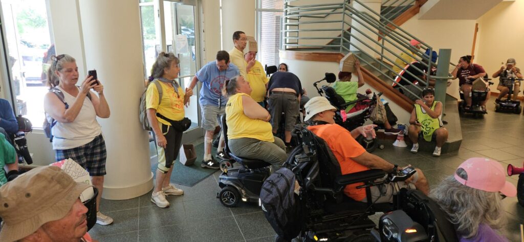 Crowd in Raleigh Housing Authority lobby.