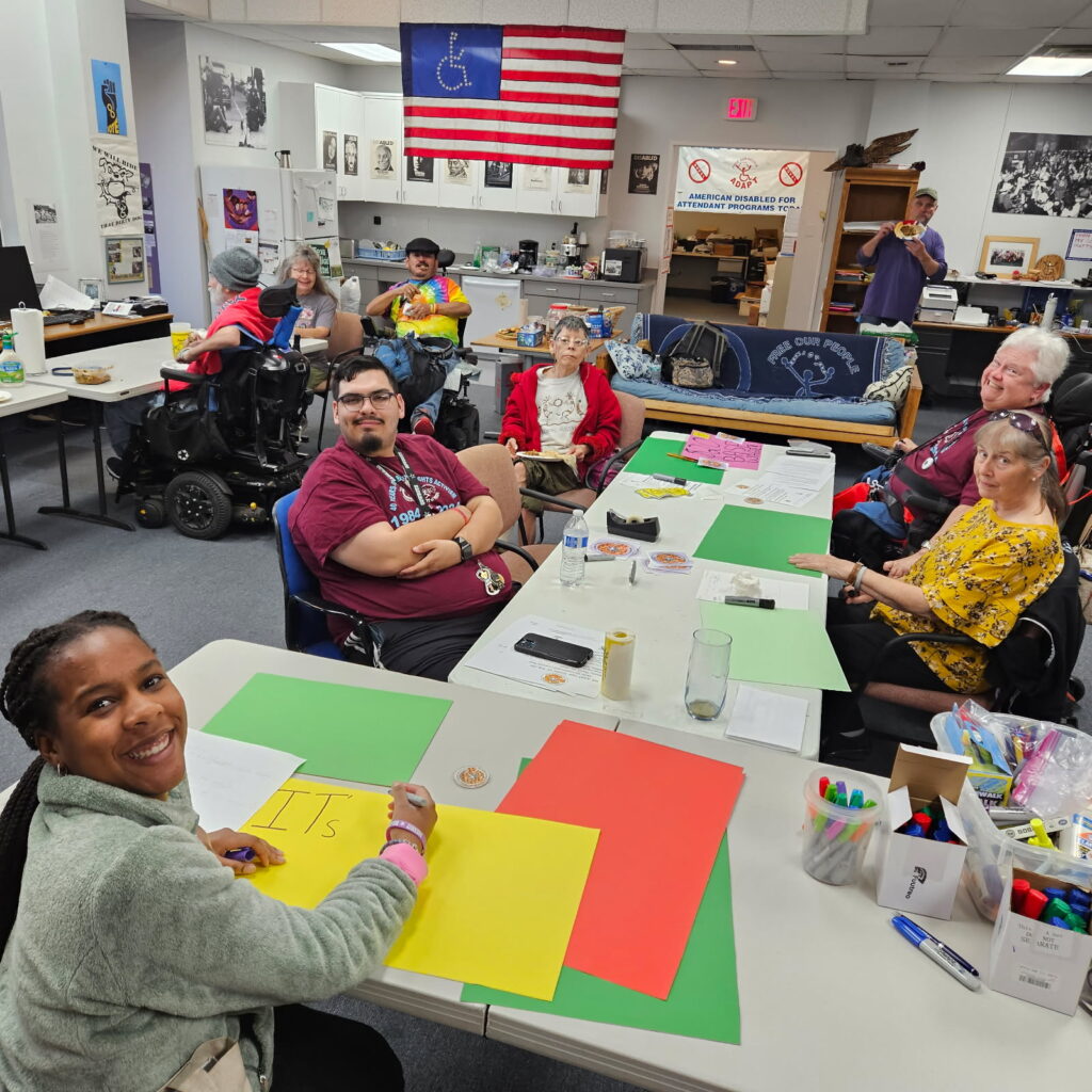 Group of people making signs at ADAPT headquarters